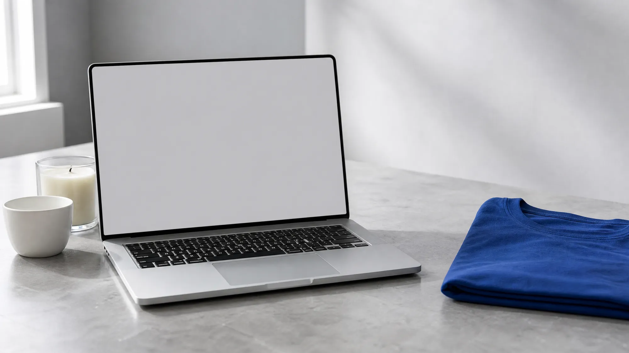 A laptop on a stone desk showing the Shopdrop home screen