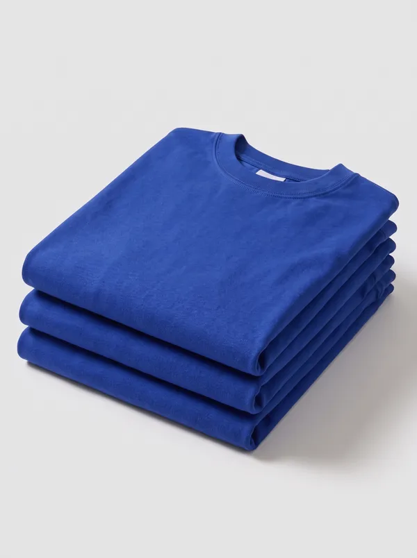 Three of the tees folded in a stack